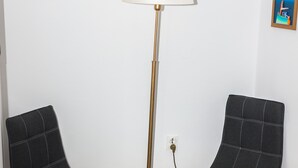 Two black upholstered chairs with wooden legs and a floor lamp with a white shade. - Apartment Basic - One Bedroom Apartment (Dubrovnik)