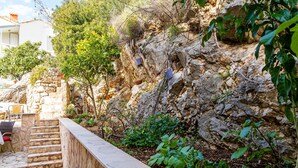 A stone staircase leading up to a white building with outdoor seating. - Sea View Apartments - Two Bedroom Apartment with Balcony and Sea View Lenka (Dubrovnik)