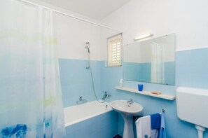 Bathtub, hair dryer, towels