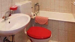 A bathroom with a sink, toilet, and bathtub.