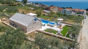 A stone building with a swimming pool and a view of the sea. - Villa Blue Sky - Three Bedroom Villa with Pool (Bol)