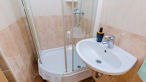 A modern bathroom with a glass-enclosed shower, a white sink, and a towel rack. - The Point Room - Double Room with City View (Dubrovnik)