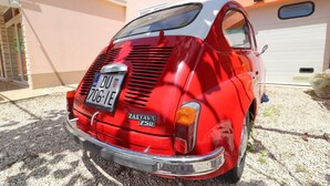 A vintage red van parked in front of a house with a garage. - Apartments Villa Michele-Three Bedroom Apartment with Partial Sea View ( Grejp ) (Orebic)