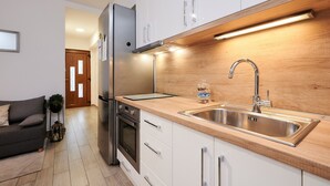 A modern kitchen with white cabinets, a stainless steel sink, and a built-in oven. - Apartment Boris (ST) - Two Bedroom Apartment with Terrace and Jacuzzi (Trogir)