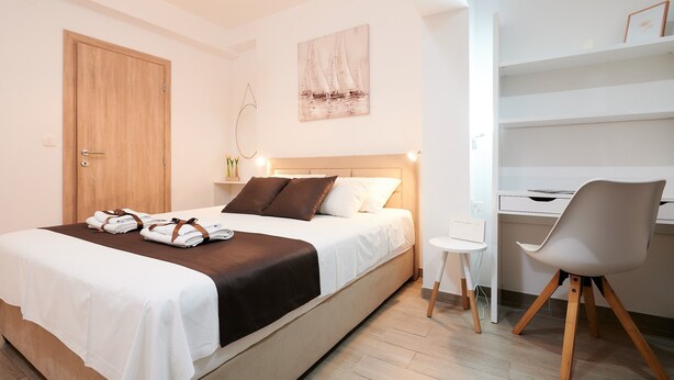 A bedroom with a bed, bedside table, chair, desk, and a painting on the wall. - Apartment Boris (ST) - Two Bedroom Apartment with Terrace and Jacuzzi (Trogir)