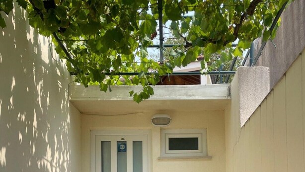A small patio area with a white door, a small window, and a tiled floor. - Guest House Luce- Studio with Terrace and Garden View (Dubrovnik)