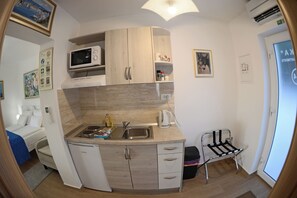 Enjoy a compact room with a kitchenette, city view, and seating area.