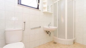 A bathroom with a toilet, sink, and shower. - Apartments Čiovo - Comfort One Bedroom Apartment with Terrace (Okrug Gornji)