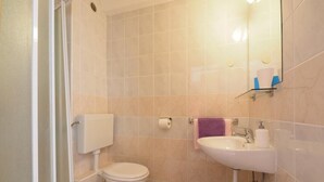 A bathroom with a toilet, sink, and shower area. - Apartments & Room Eva Slano- Double Room with Balcony and Sea View (Slano)