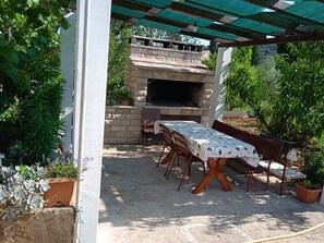 Enjoy al fresco dining in this charming patio area, complete with a barbecue oven and comfortable seating.