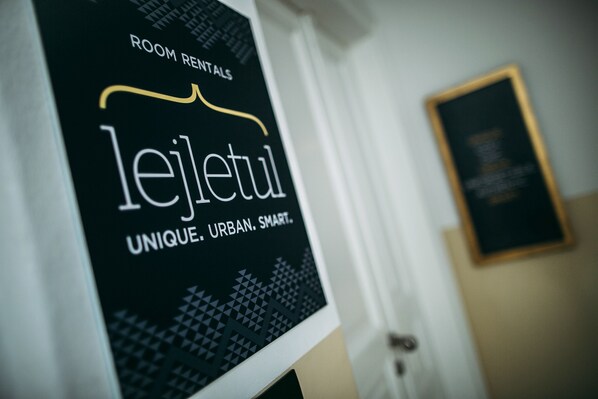 A sign for 'le jeltul' with the text 'ROOM RENTALS' and 'UNIQUE. URBAN. SMART.'