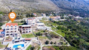 A coastal village with a prominent building labeled "Apts. Sandito."
