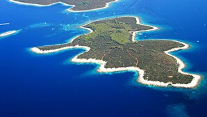 Vista aérea de un archipiélago con aguas azul turquesa y playas de arena blanca.