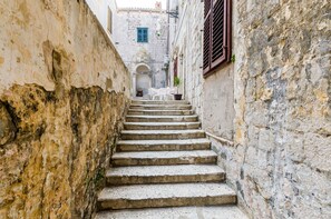 A narrow stone staircase leading up to a building entrance.