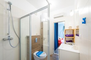 A modern bathroom with a glass shower enclosure, a white toilet, and a wooden vanity with a mirror. - Captain's Studio - Studio with Terrace (Mokosica)