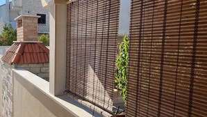 Ein Balkon mit einem Metallgitter und einem Blumentopf.