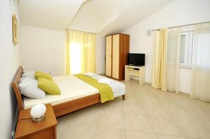 Cozy retreat with a comfortable bed, bedside table, and TV.