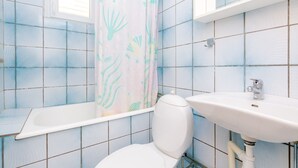 A bathroom with a bathtub, toilet, and sink. - Villa Bind Twin Room with Patio and Garden View R1 (Obod)