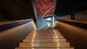 A staircase with granite steps and a modern ceiling design with hanging lights. - Scandic Voss (Voss)