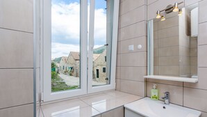 A modern bathroom with a large window, a sink, and a mirror. - Apartments Saint Mary - Studio Apartment (Apt. 2) (Dubrovnik)