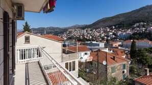 Un quartier résidentiel avec des immeubles, une montagne et un ciel dégagé.