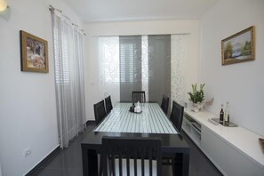Enjoy meals with family and friends in this dining area, featuring a table for four and comfortable seating.