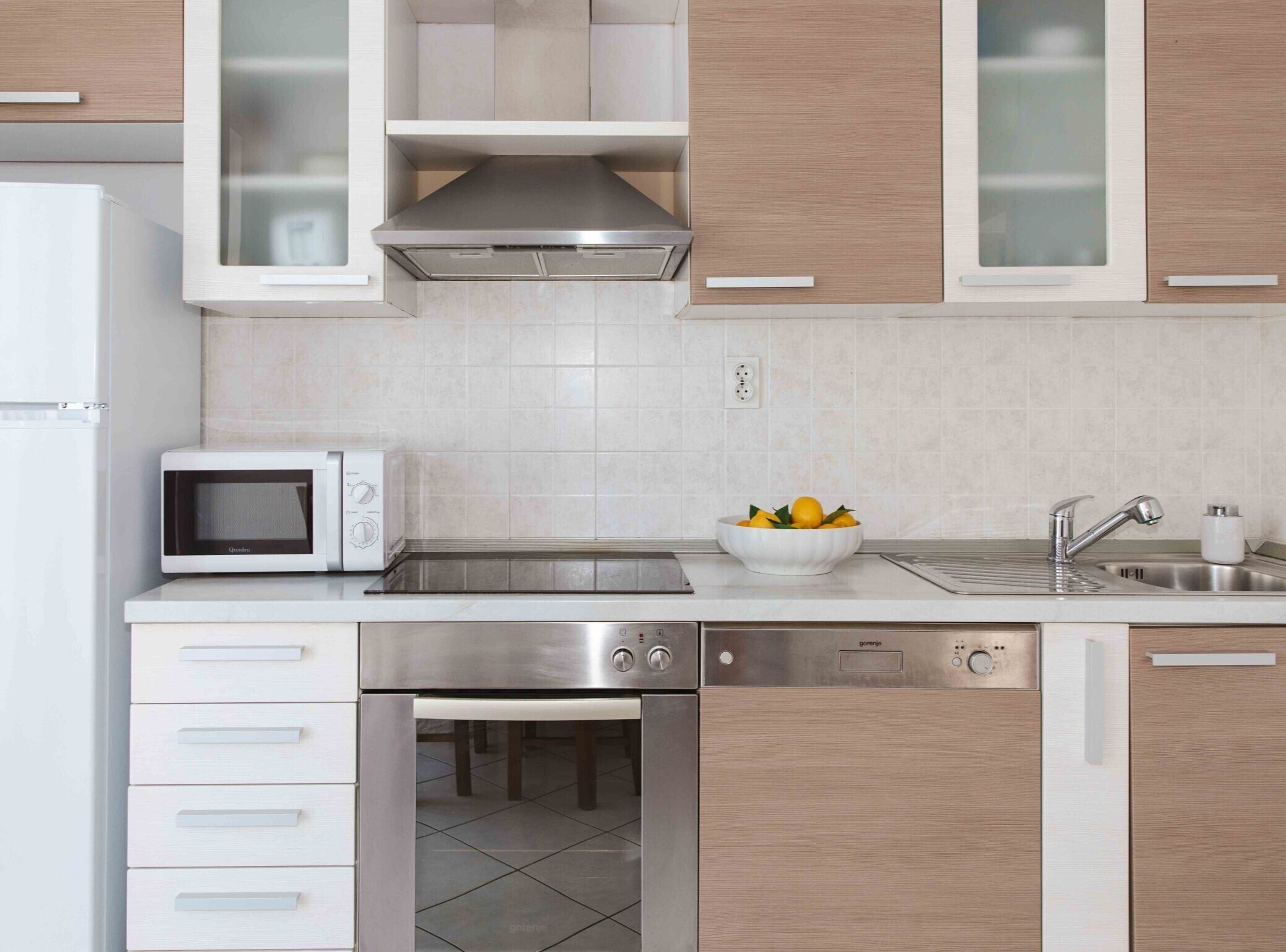 A modern kitchen with a microwave, sink, and dishwasher.