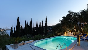 A swimming pool with a view of the sea, surrounded by trees and a patio area with lounge chairs. - Apartment Rea Zaton - Two-Bedroom Apartment (Zaton)