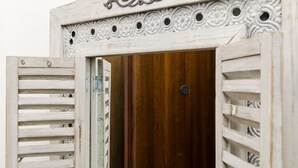 A rustic wooden door with intricate carvings and a metal handle.
