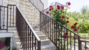 A staircase with stone steps and black metal railings, leading to a building entrance. - Apartments & Rooms Cina - Studio Apartment with Sea View (Cavtat)