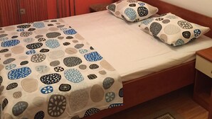 A bedroom with a bed, pillows, a chair, a wall with a mural, and a window with blinds. - Apartments Roko (ST) - Economy One Bedroom Apartment with Shared Terrace (A2) (Split)