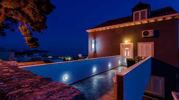 A rooftop terrace with a pool, a sign indicating 'Best House', and a view of the cityscape at dusk. - Guest House Nikolina - Double Room with Balcony and Sea View(1) (Dubrovnik)