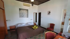 A bedroom with a bed, a chair, a desk, and a mirror. - Apartments Cervelin - Two-Bedroom Apartment with Two Terraces and Sea View (Lopud)