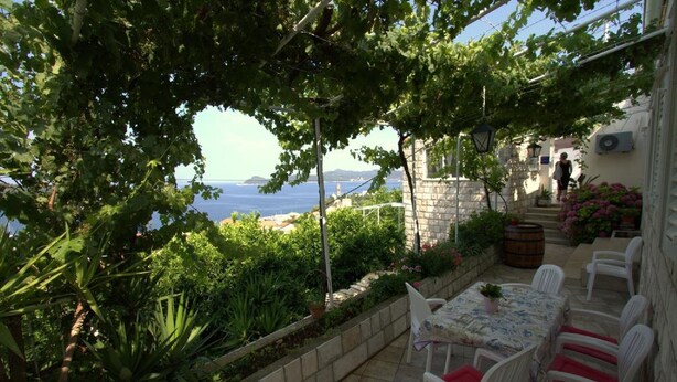 A terrace with a table and chairs, overlooking a coastal view. - Apartments Cervelin - Two-Bedroom Apartment with Two Terraces and Sea View (Lopud)
