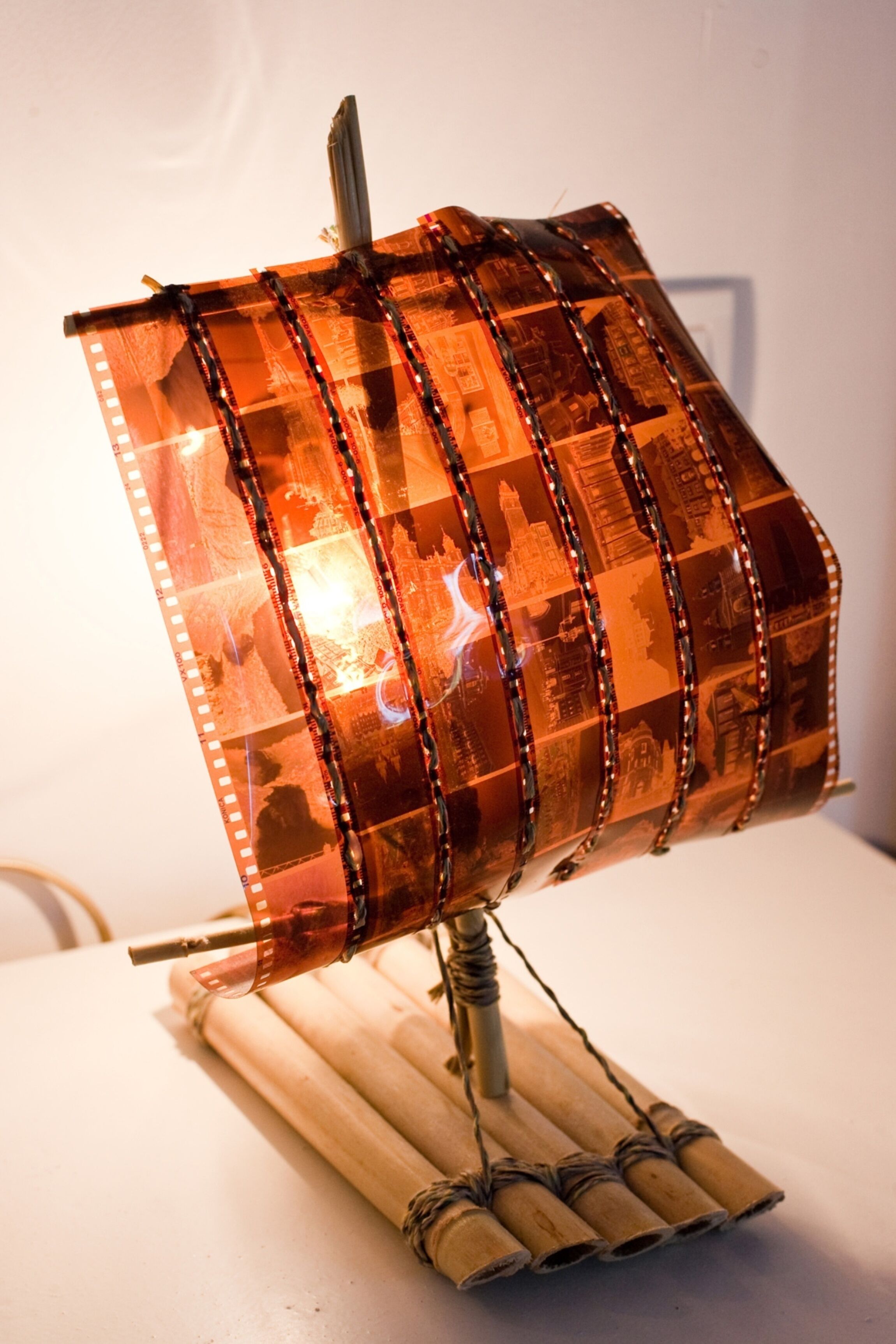 A decorative lamp with a cylindrical shape and a patterned surface.