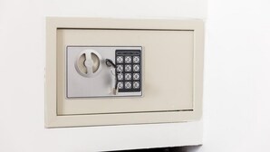 A keypad lock on a white door.