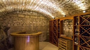 A stone-walled room with a wooden bar and wine racks. - Rooms Miron -  Superior Double or Twin Room with Sea View (Sumartin)