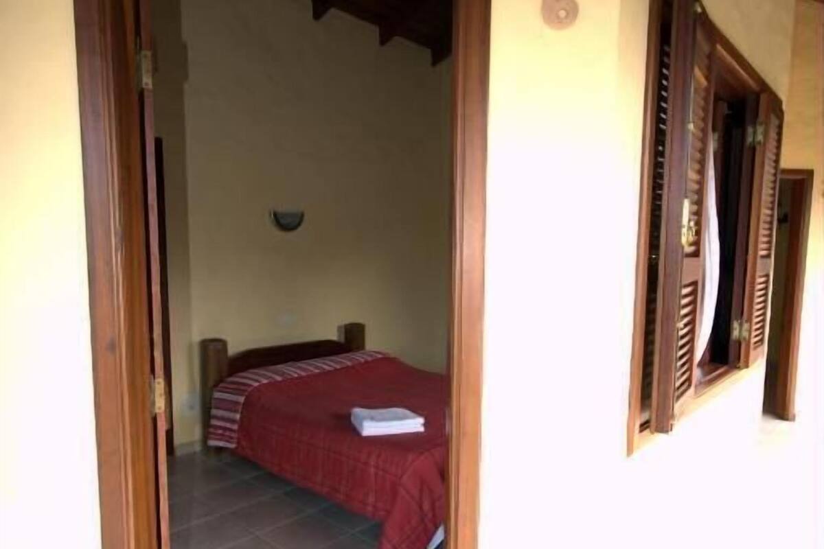 A room with a bed, a door leading to another room, and a number '6' on the wall.