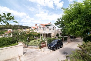 Stunning two-story house with a red-tiled roof and balcony.