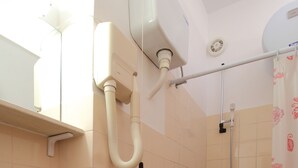A bathroom with a sink, toilet, shower, and a towel rack. - Apartments Magda- Superior Studio Apartment with Patio and Garden View (Cavtat)