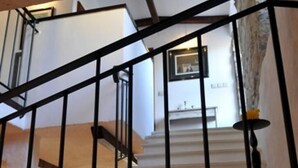 A staircase with a black metal railing leading to a landing.