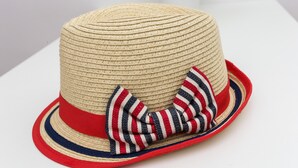 Un sombrero de paja con un lazo rojo y azul.