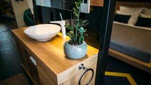 A wooden vanity with a white bowl, a potted plant, and a towel holder. - Rooms Lejletul  - Deluxe Double Room with Square View (Berat) (Split)