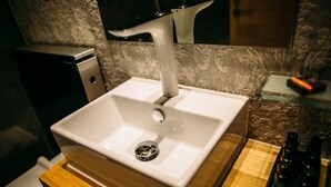 A bathroom with a white sink, a modern faucet, and a wooden countertop. - Rooms Lejletul  - Deluxe Double Room with Square View (Berat) (Split)