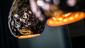 A close-up of a textured, metallic light fixture with a warm glow. - Rooms Lejletul  - Deluxe Double Room with Square View (Berat) (Split)