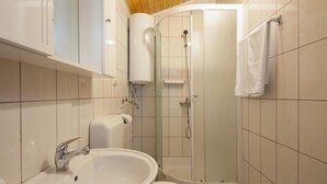 A bathroom with a sink, toilet, shower, and a towel rack. - Apartments Eastern Paradise- Comfort One Bedroom Apartment with Terrace and Sea View (Bol)