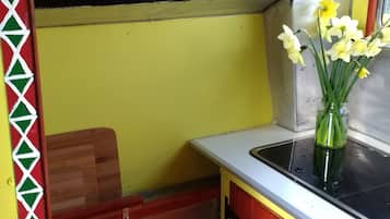 Stovetop, electric kettle, cookware/dishes/utensils, dining tables