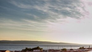 A coastal view with houses and a body of water. - Apartments Villa Angela - One Bedroom Apartment with Terrace and Sea View (Baška Voda)