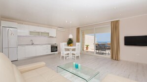 A modern apartment with a kitchen, dining area, and a balcony with a view. - Big Blue Apartments - Superior One Bedroom Apartment with Terrace and Sea View (Superior 4) (Dubrovnik)