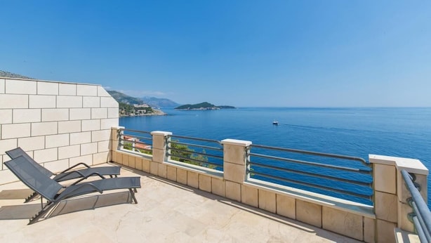 A balcony with two sun loungers overlooking a clear blue sea and a distant island. - Big Blue Apartments - Superior One Bedroom Apartment with Terrace and Sea View (Superior 4) (Dubrovnik)